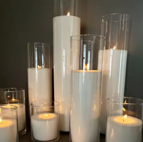 Sand wax granules filling a clear glass vase candle