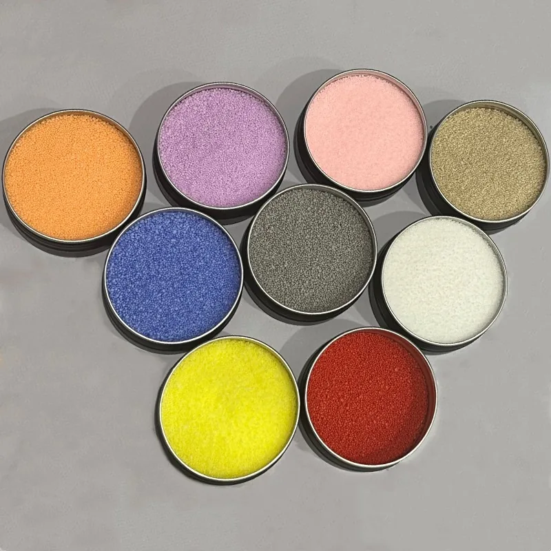 Sand-wax colour range shown in sample tins